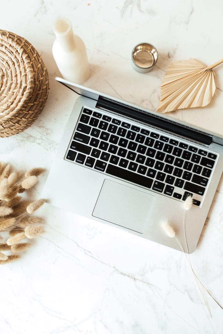 Laptop and Modern Minimalist Decors on White Marble Table